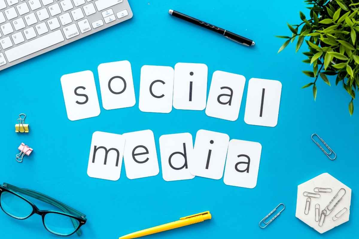 Social media text arranged on a blue background with office stationery